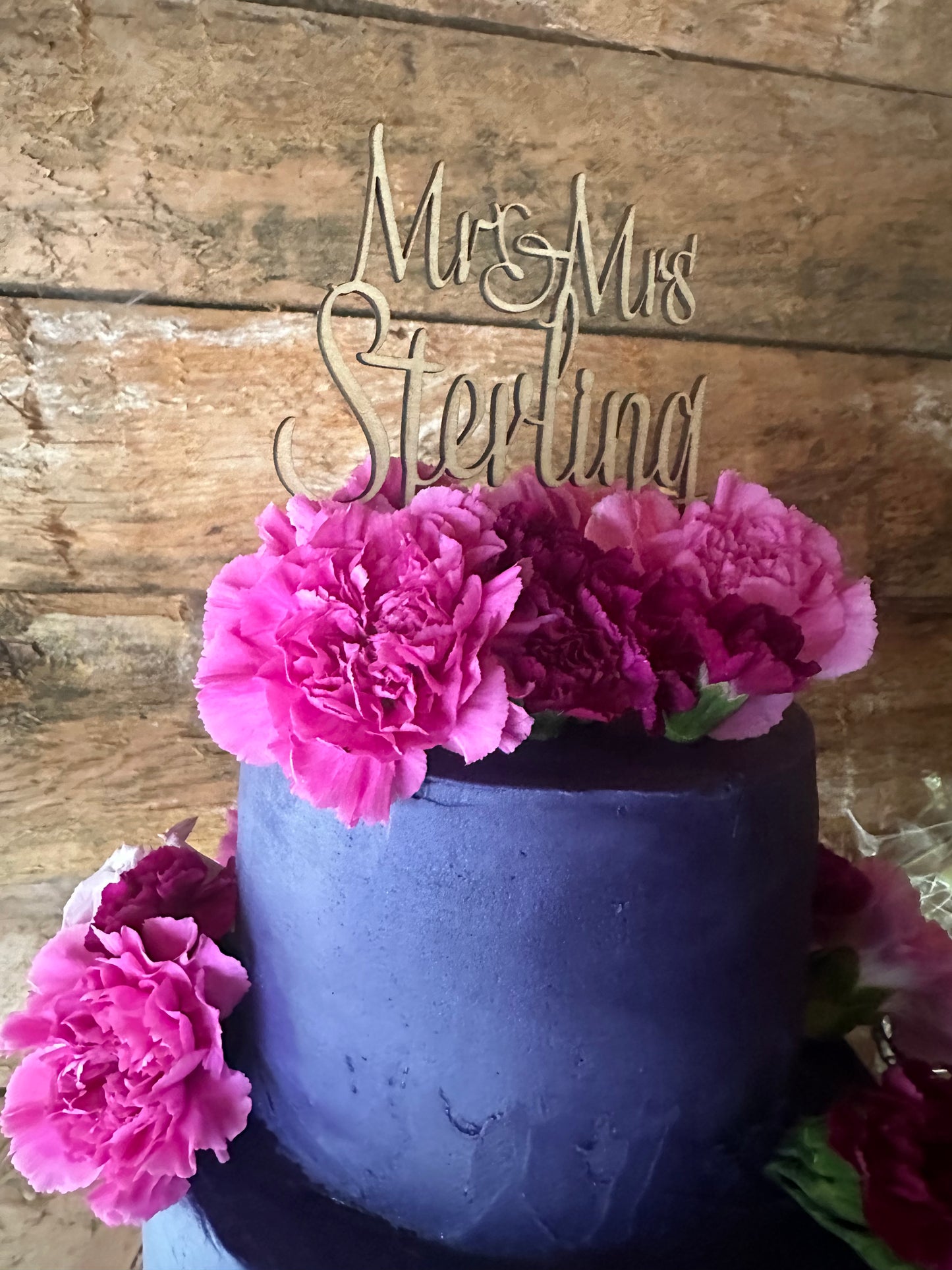 Maple cake topper on top of wedding cake