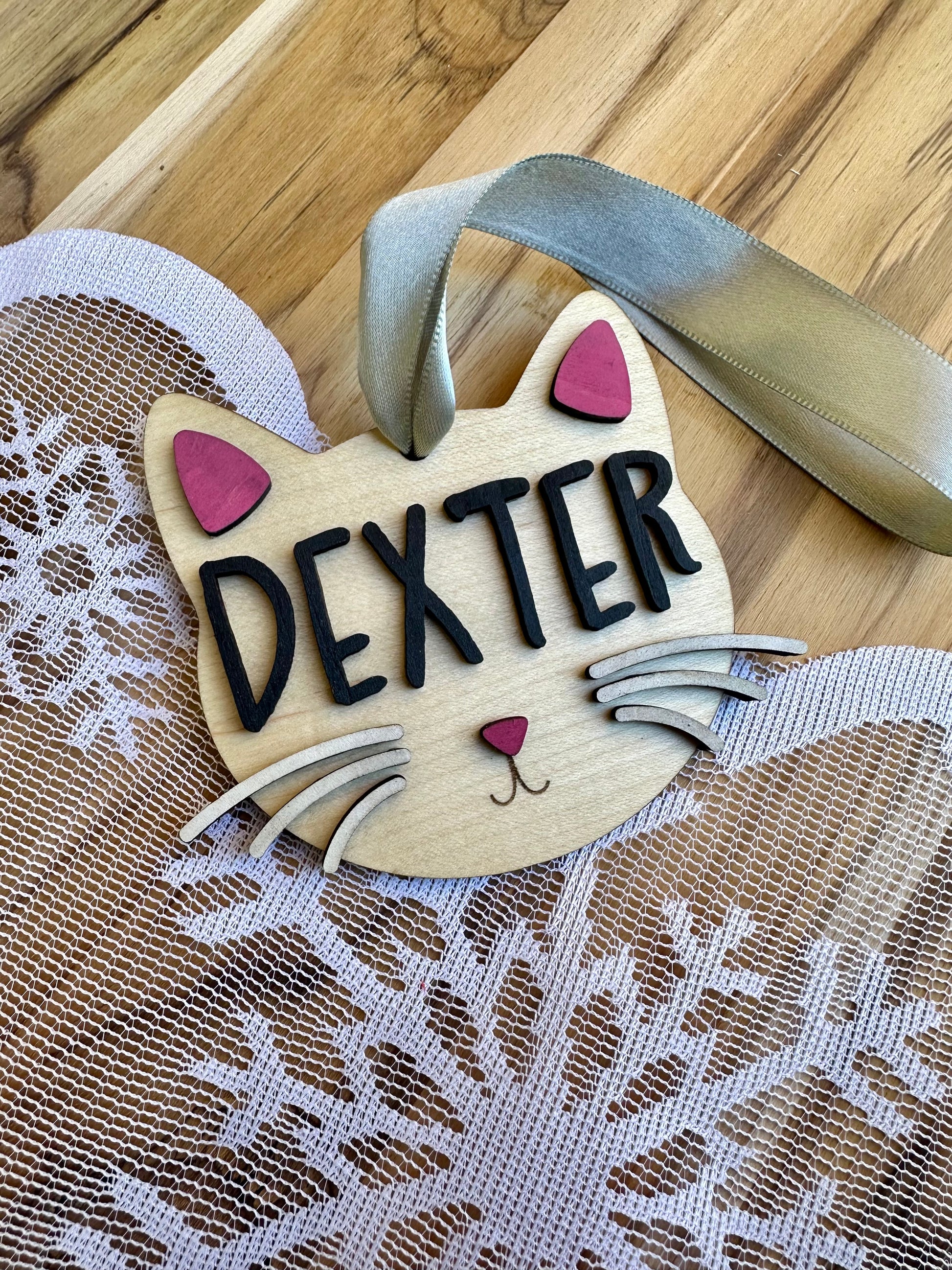 Cat ornament on maple with black lettering