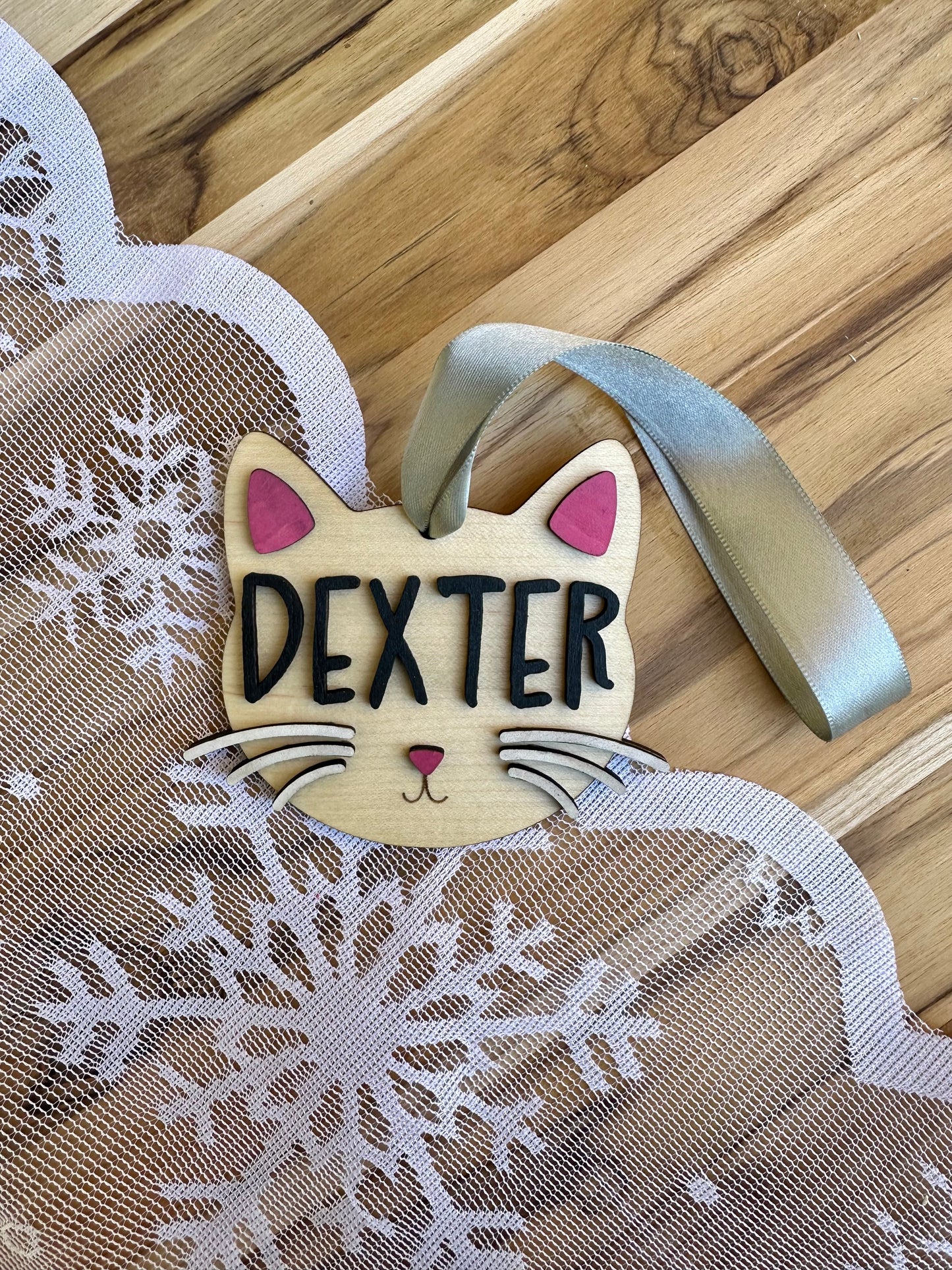 Cat ornament on maple with black lettering