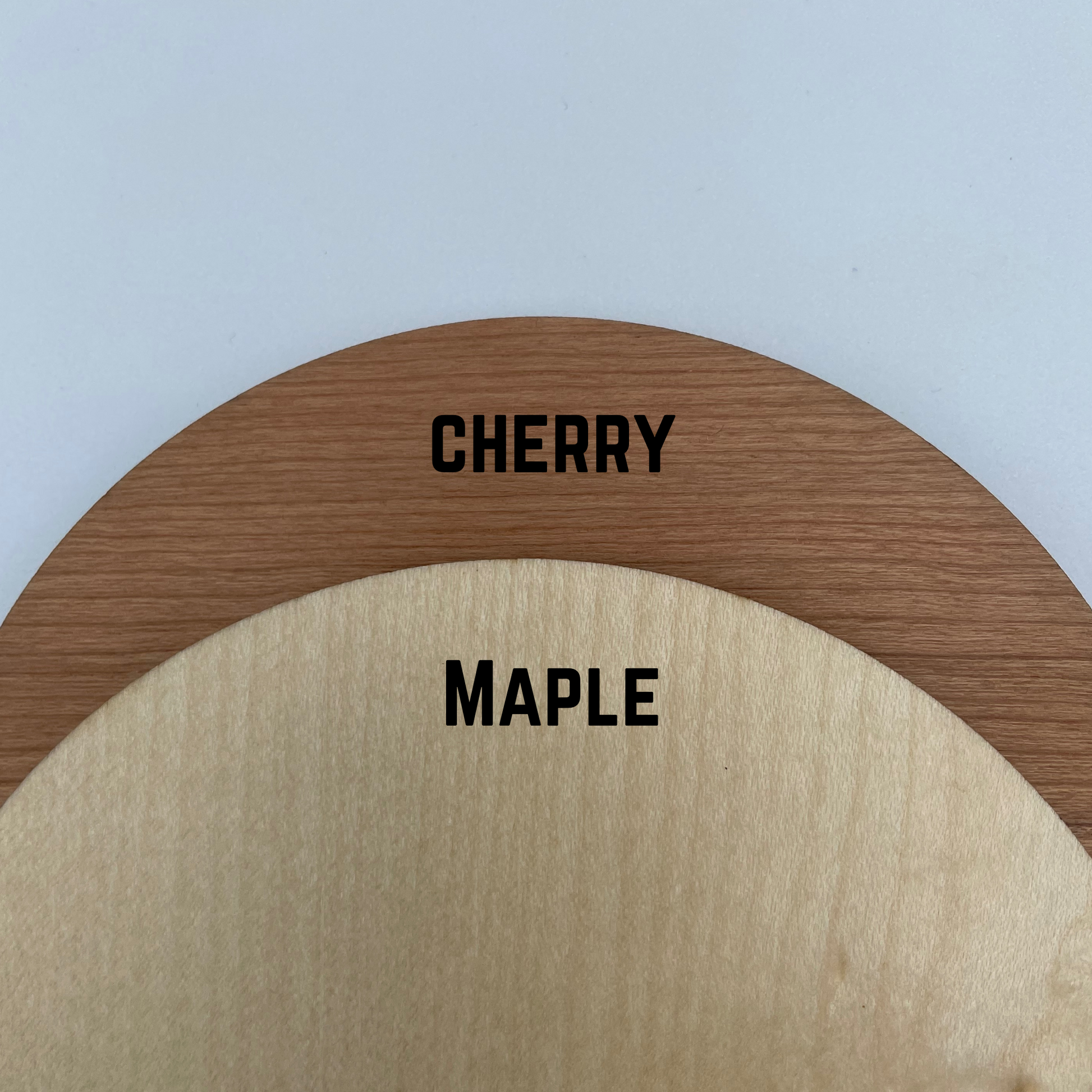 Wood type options. Top option is in cherry (a darker, more brown wood), the second option is maple (a lighter wood type)